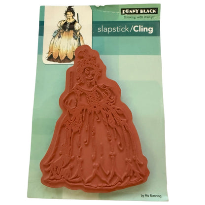 Back of a Penny Black cling stamp on a green backing showing the back of a witch stamp on a white background 