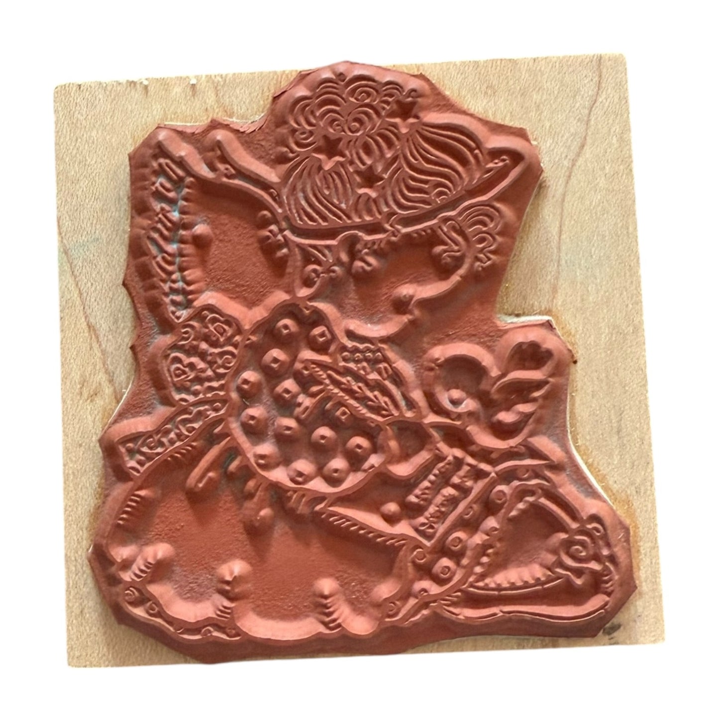 Decorative stamp with intricate design on a wooden block