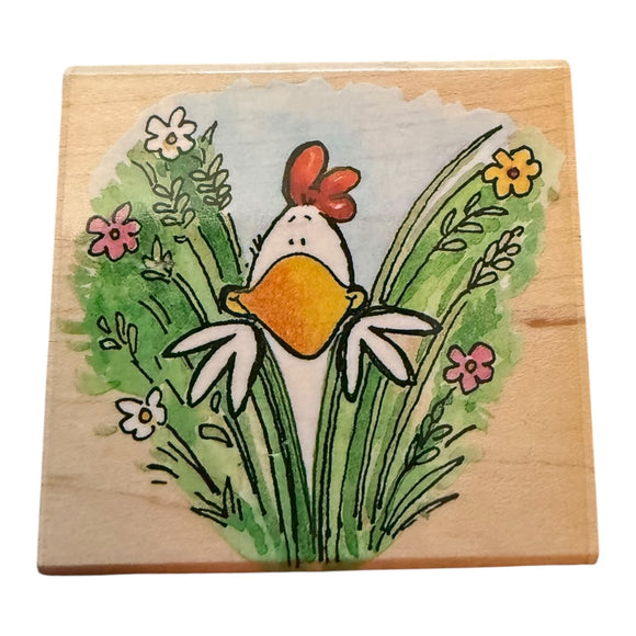 Wooden block with a painted rooster and flowers design on a white background