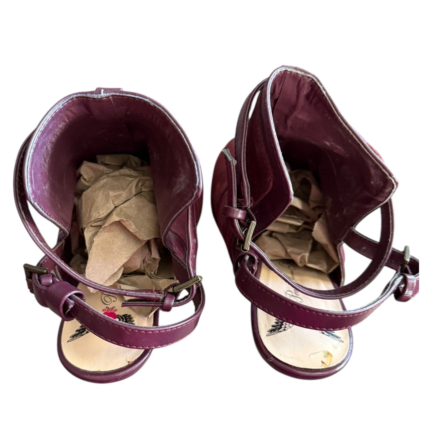 Top of maroon strappy heels on a white background