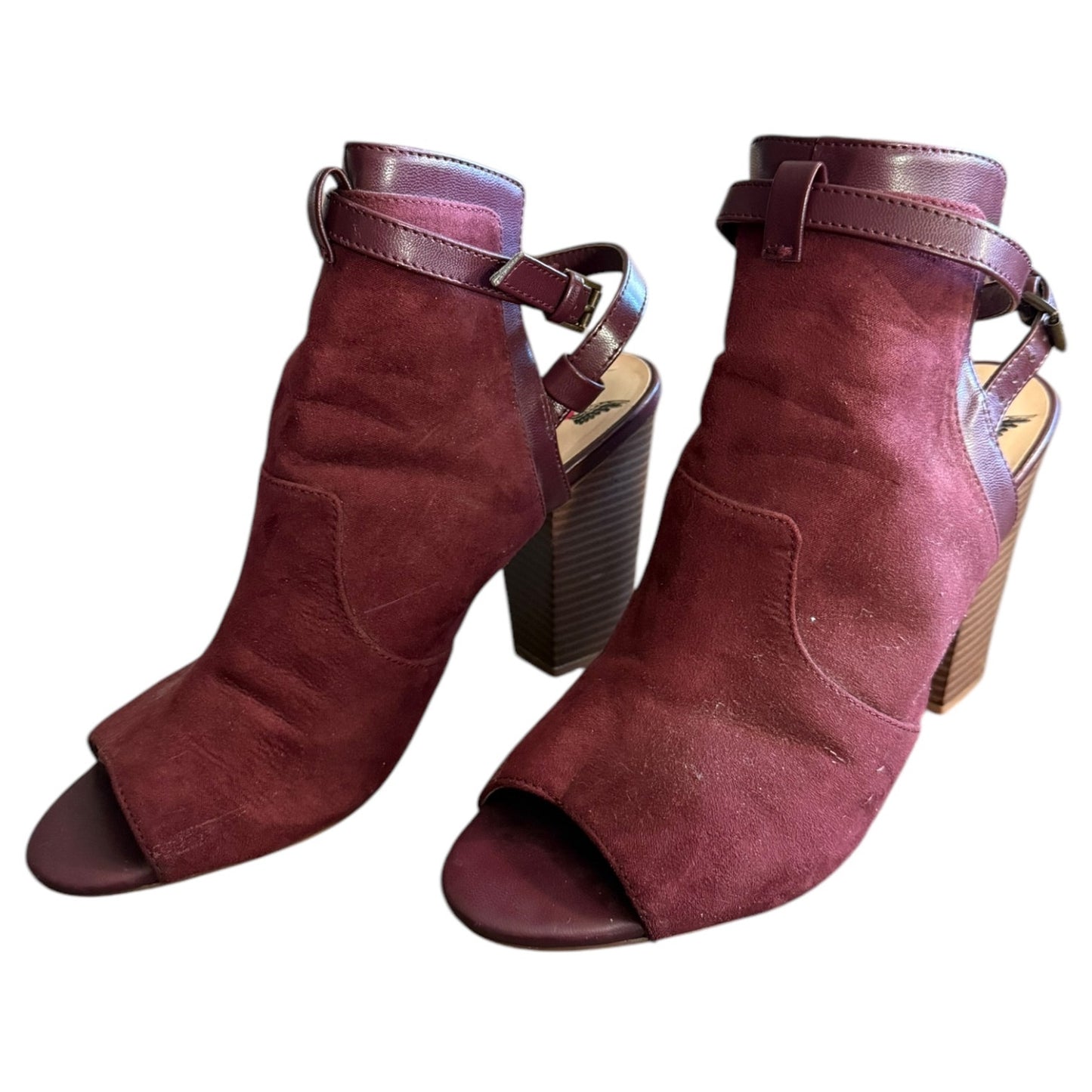 Front side of a Pair of maroon open-toe heeled shoes on a white background
