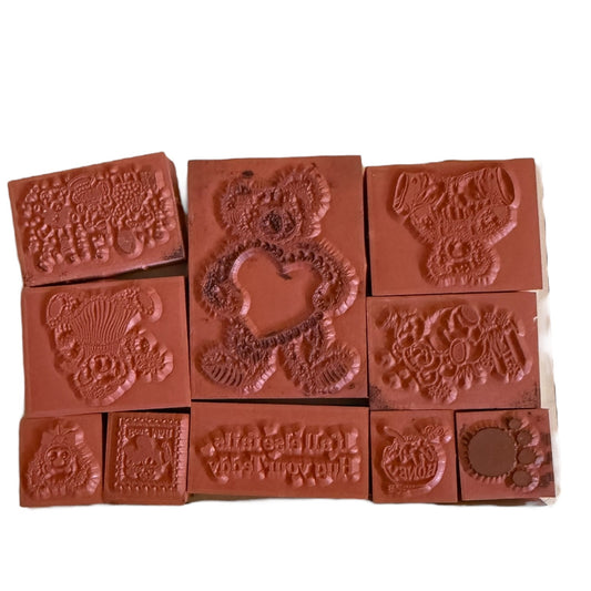 Set of nine brown rubber stamps with various bear designs on a white background