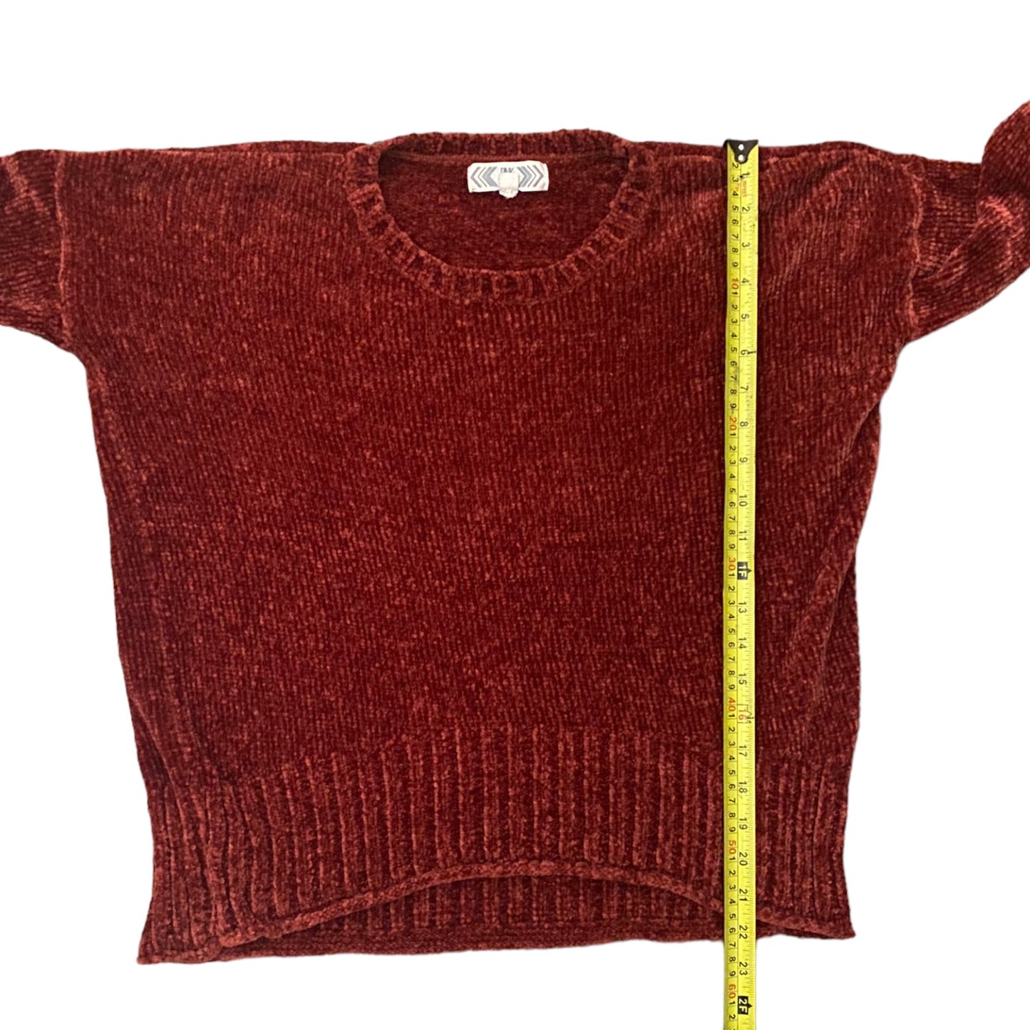 Red/pink sweater with a measuring tape on a white background