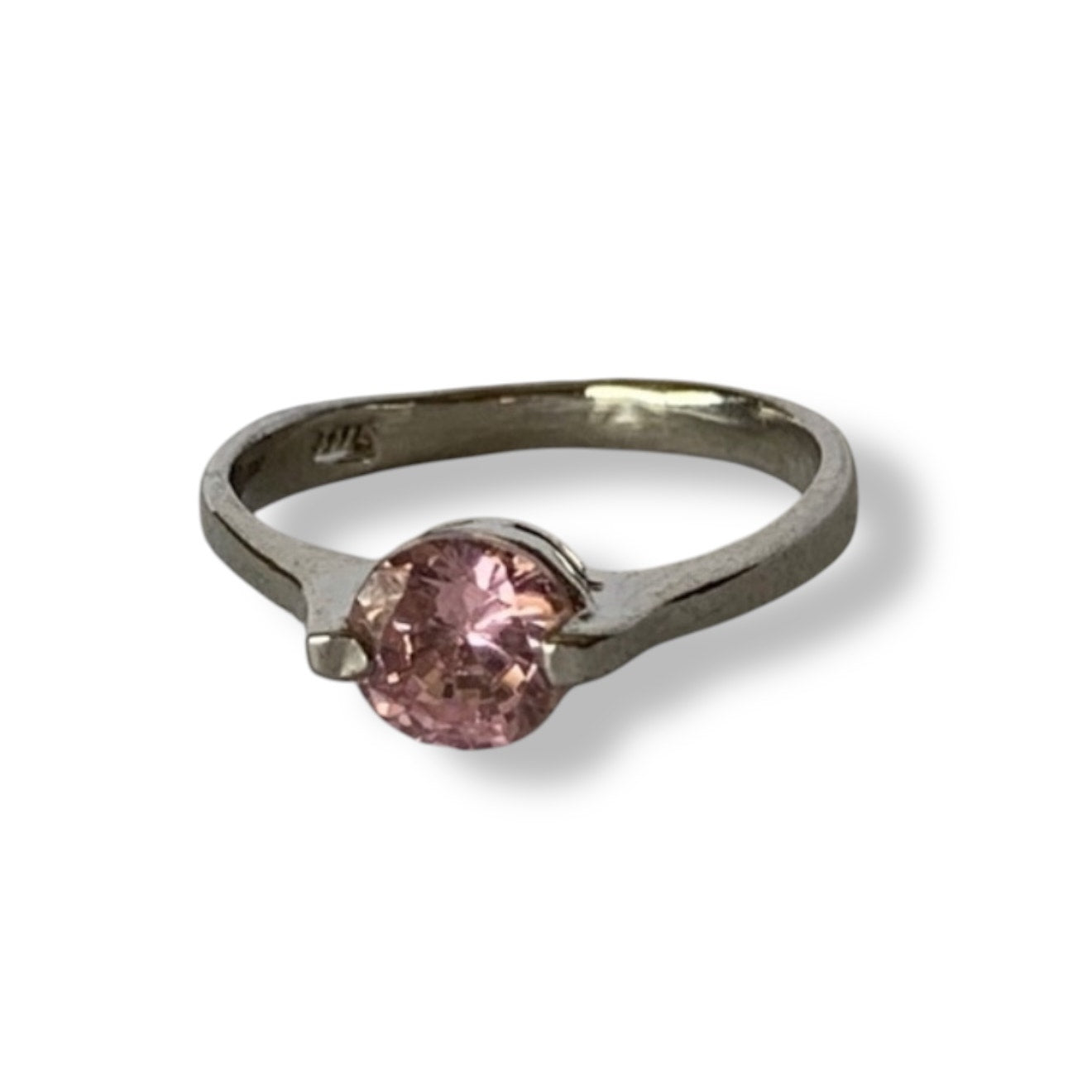 Silver ring with a pink gemstone on a white background