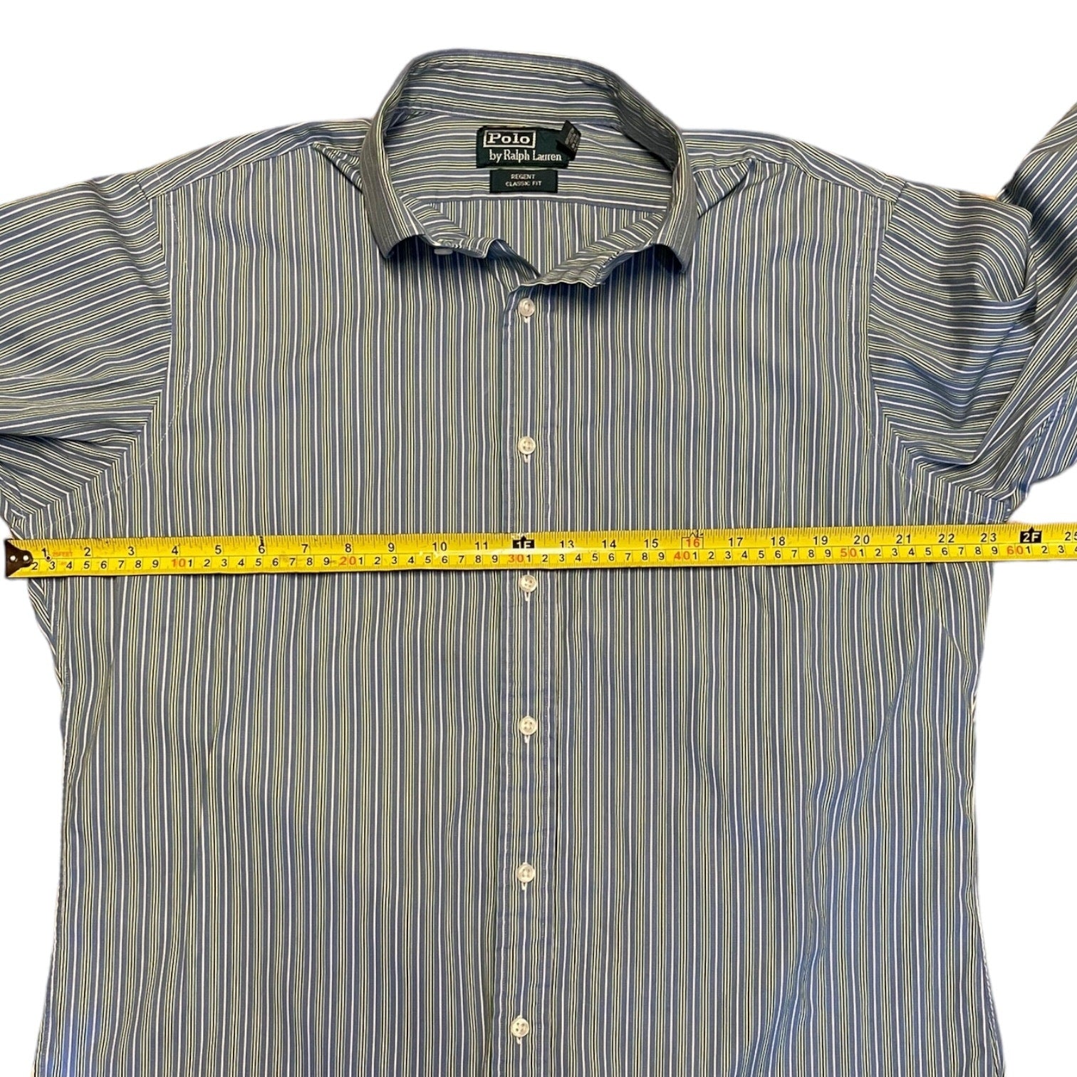 Striped shirt with Polo Ralph Lauren label, measured with a tape measure on a white background