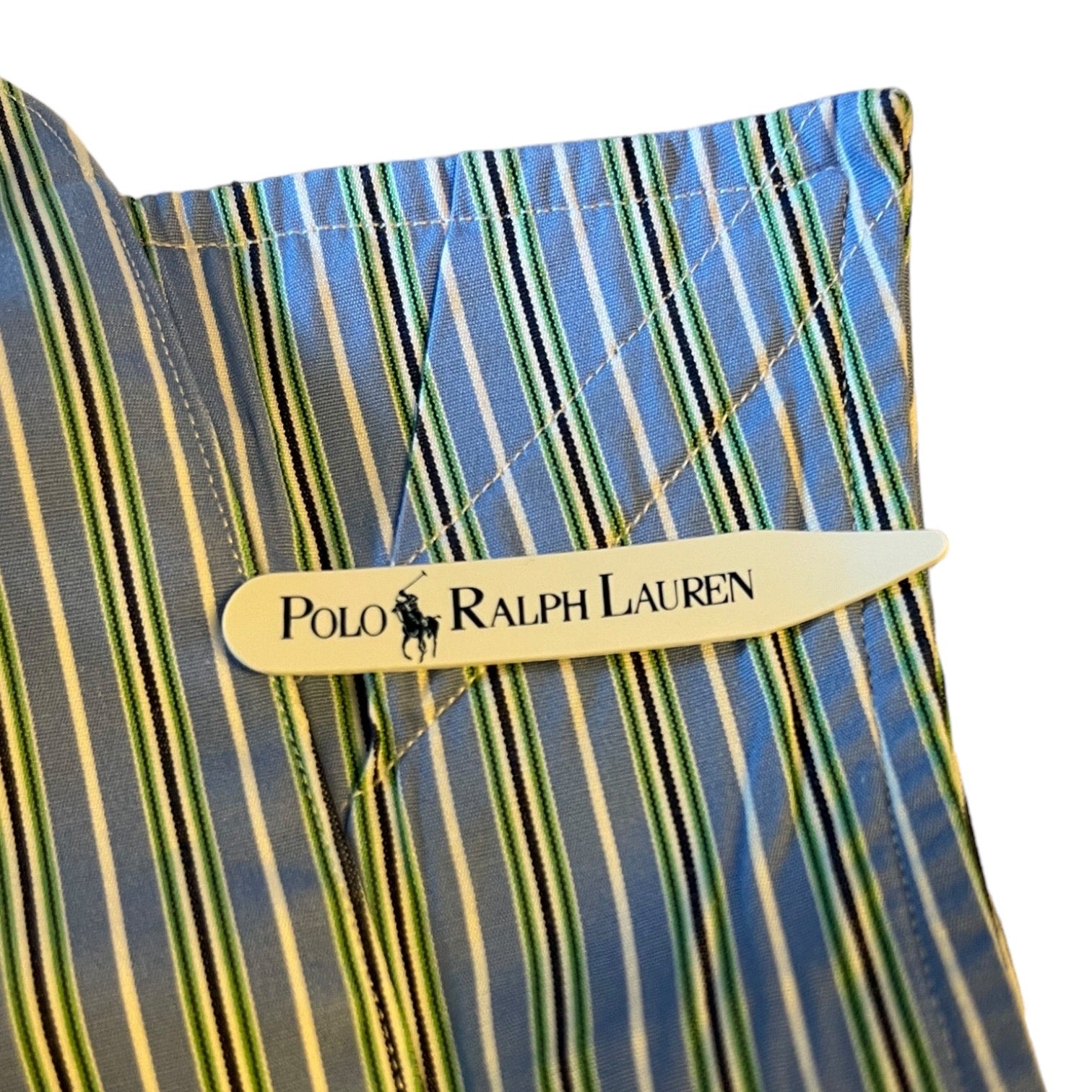 Close-up of a striped fabric with a Polo Ralph Lauren logo collar stay.
