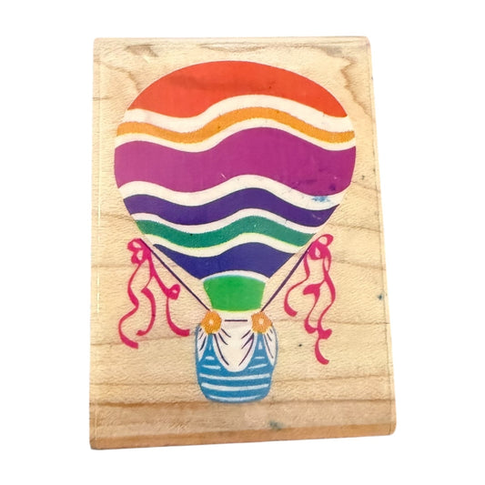 Colorful hot air balloon design stamp on a wooden block