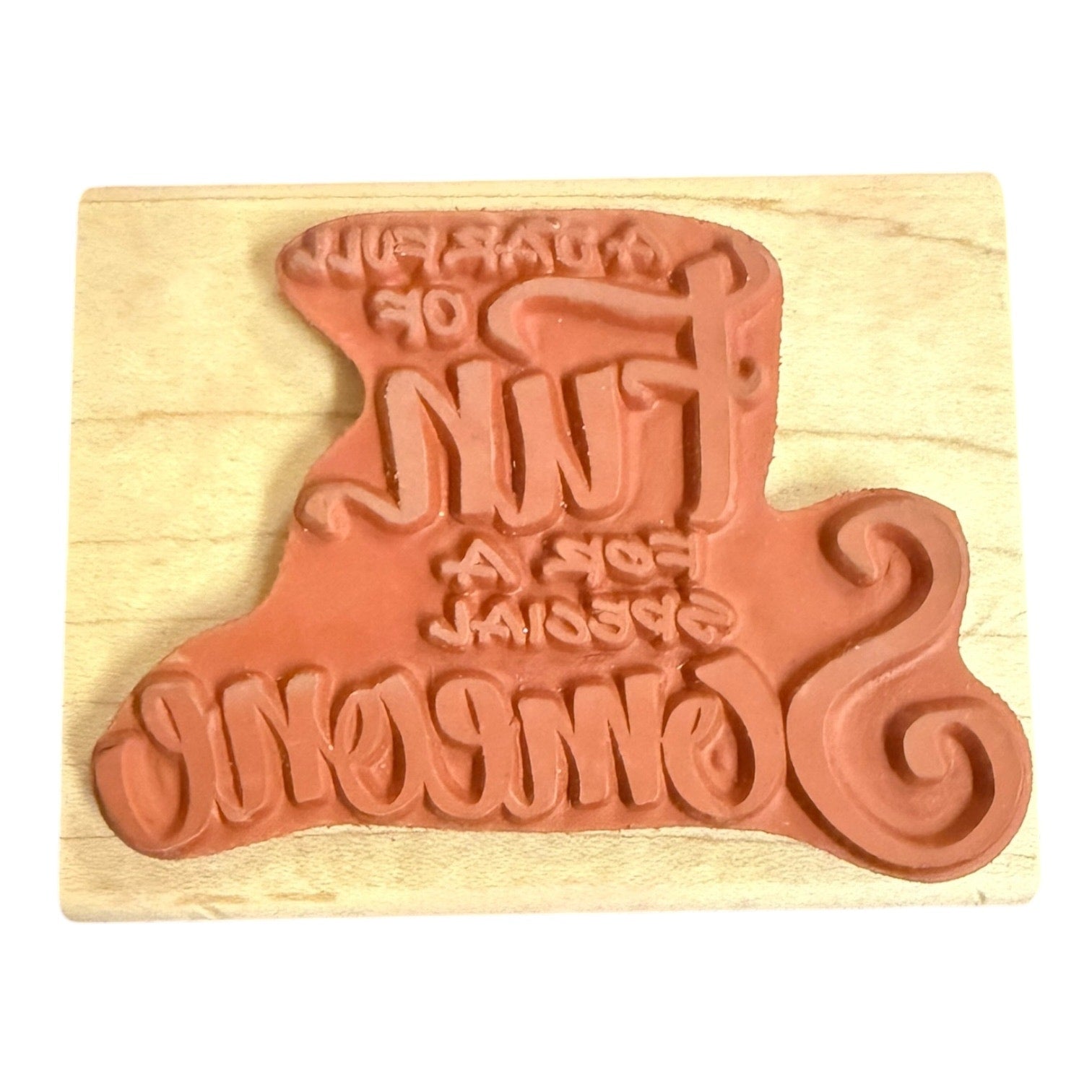 Back of rubber stamp mounted on a wood block on a white background