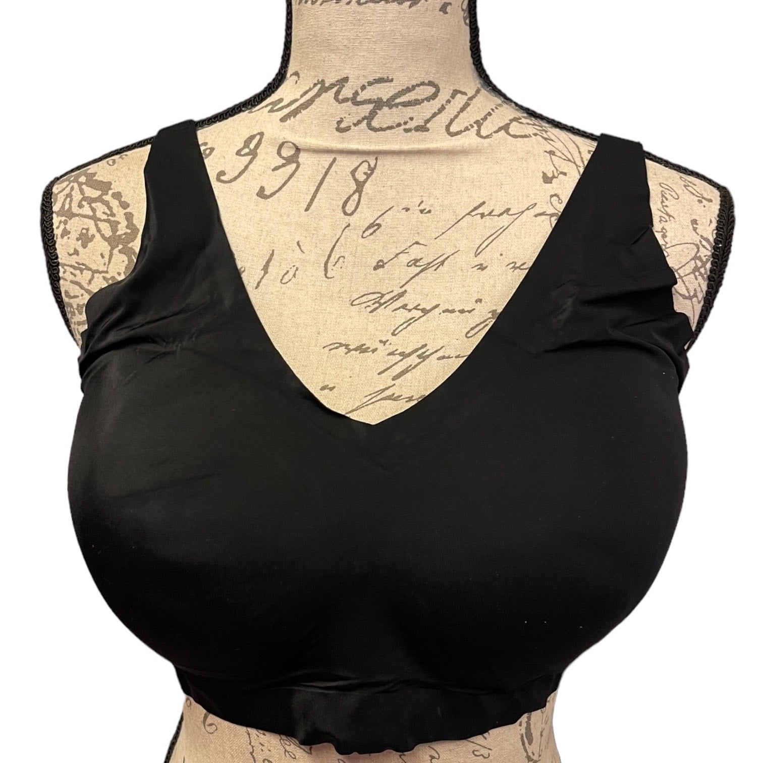 Front of Black bralette on a mannequin with a vintage-style background