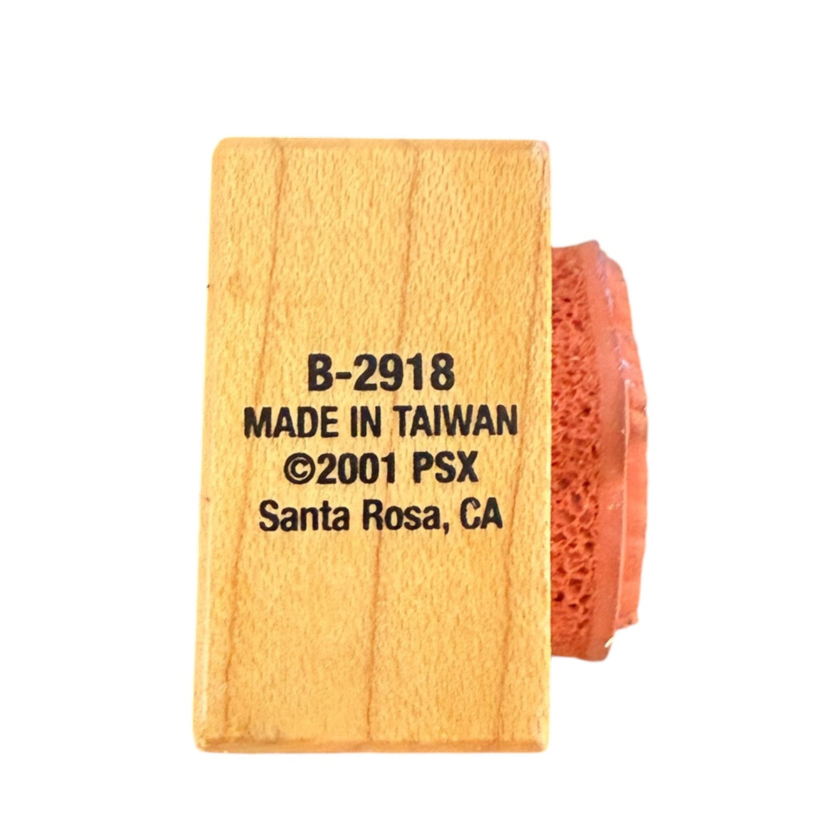 A wooden rubber stamp block with black printed text reading 'B-2918 MADE IN TAIWAN ©2001 PSX Santa Rosa, CA' on a plain white background.
