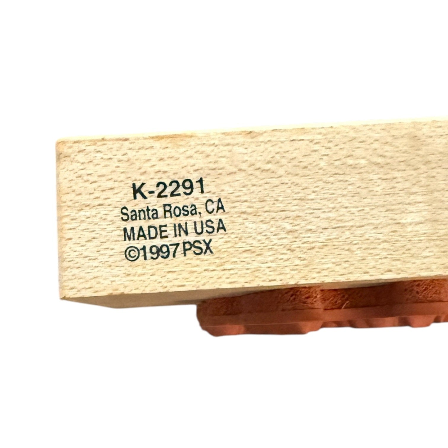 Wooden stamp with text 'K-2291, Santa Rosa, CA, Made in USA, 1997 PSX' on a white background