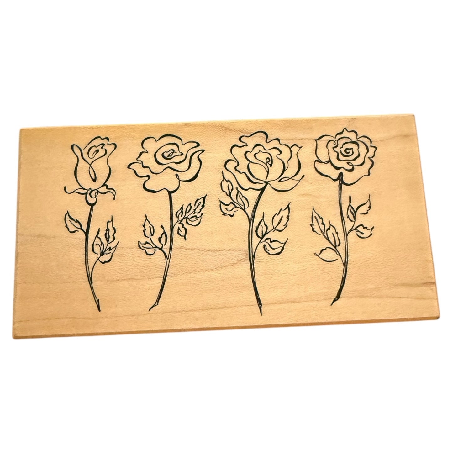 Wooden stamp with rose designs on a white background