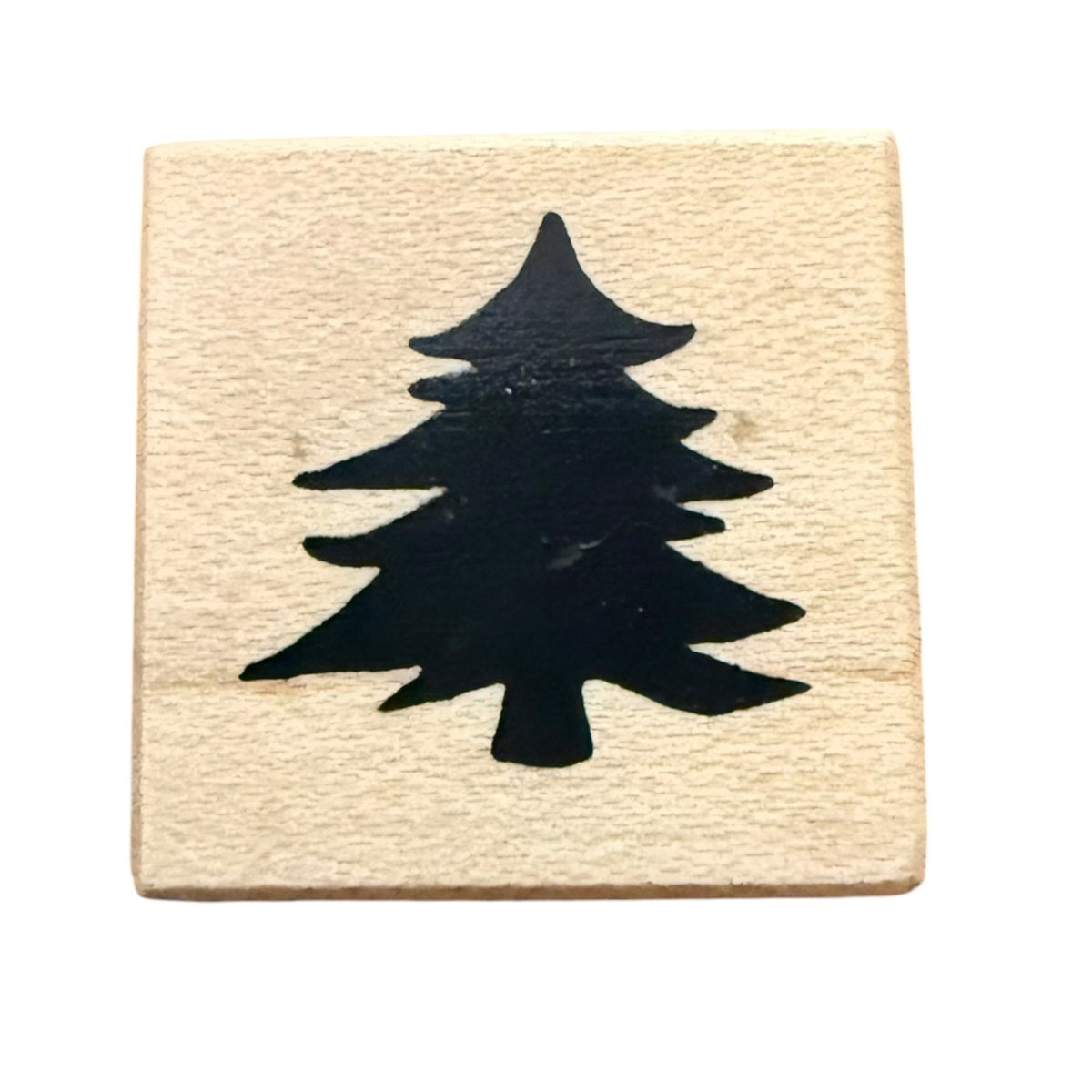 A square wooden stamp block with a black silhouette of a pine tree, shown on a plain white background.