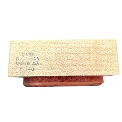 A rectangular wooden block with a textured light beige wood grain top and a reddish-brown base, featuring printed text on the top reading 'PSX Petaluma, CA MADE IN USA F-146', shown on a plain white background.