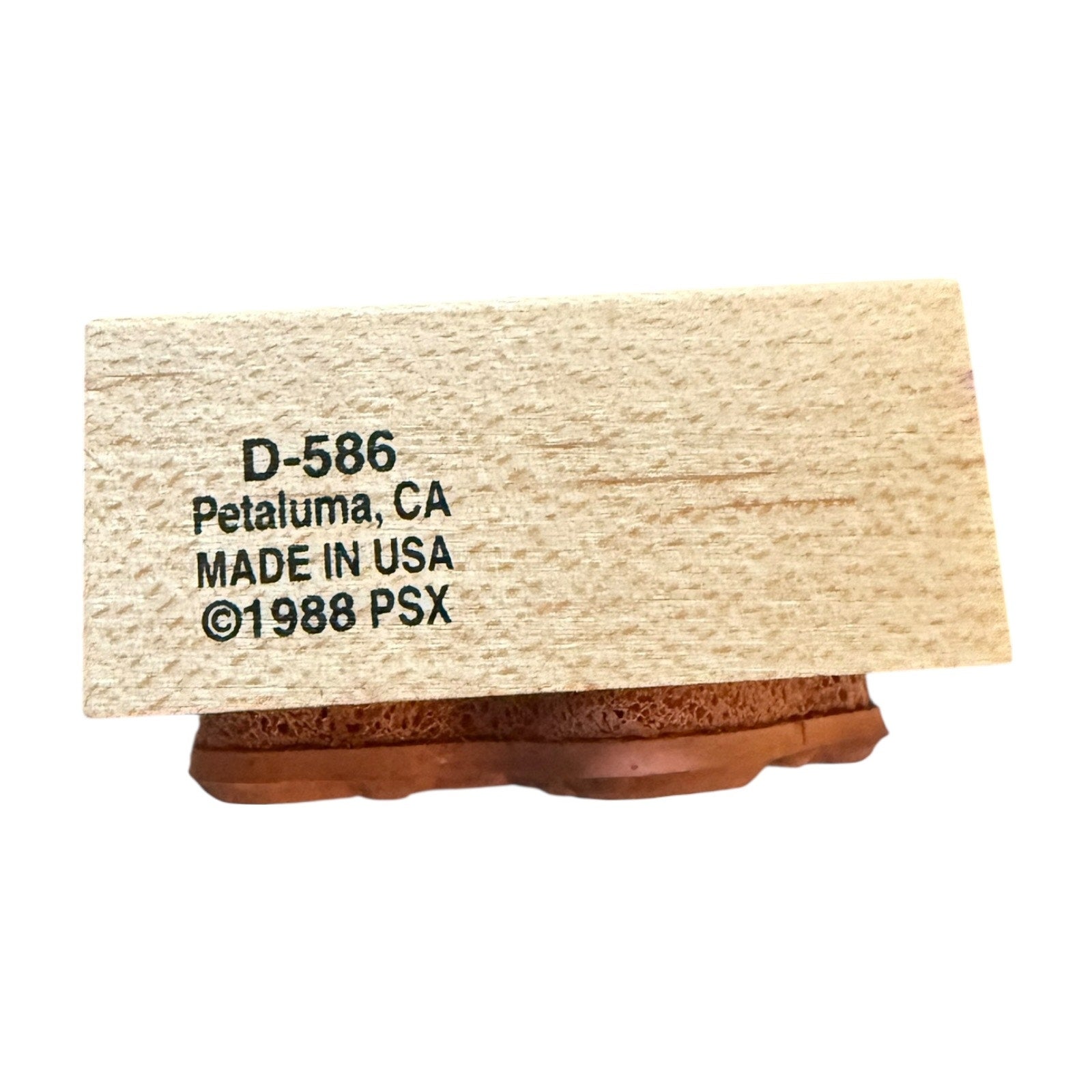 Wooden block with text 'D-586 Petaluma, CA MADE IN USA ©1988 PSX' on a white background