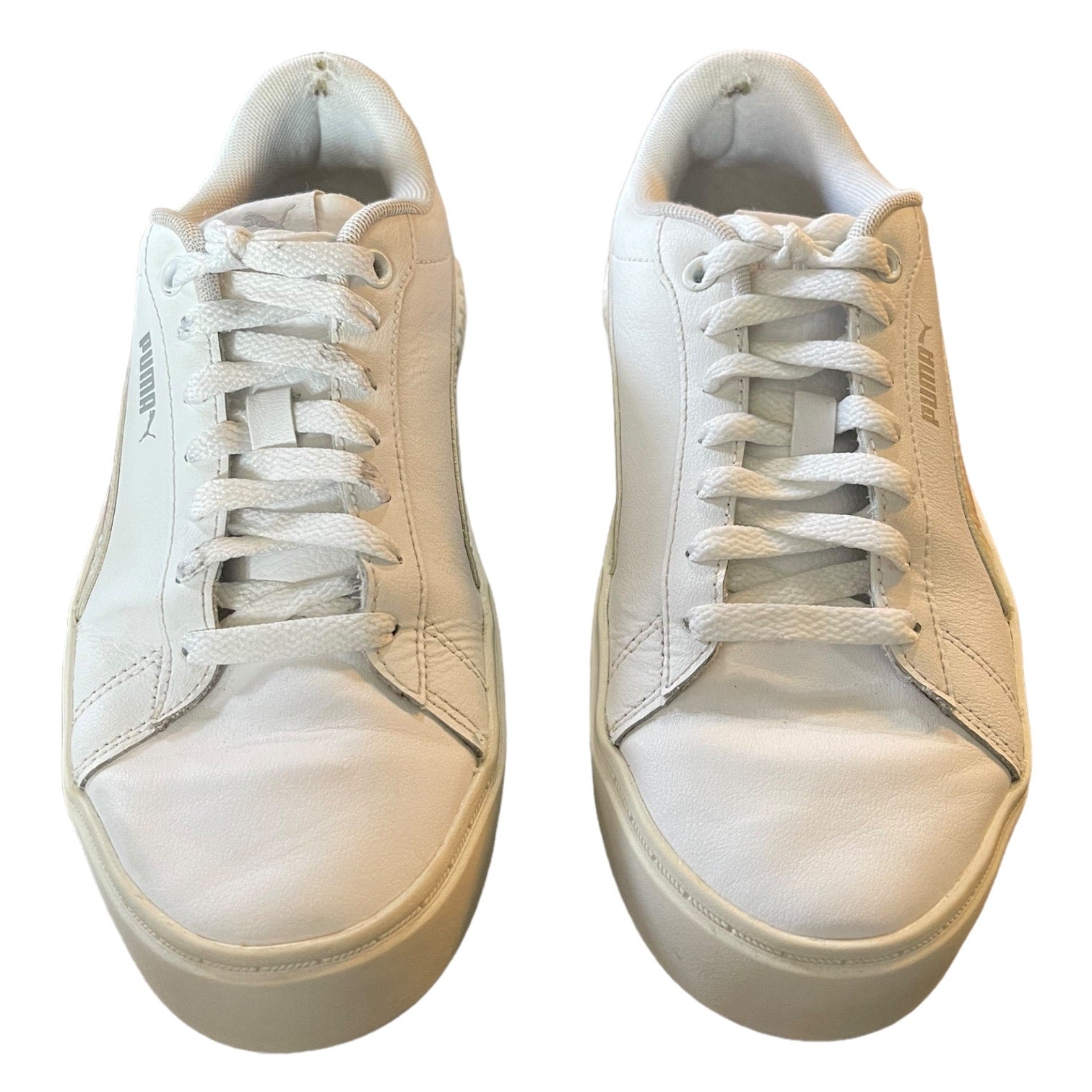 front of a Pair of white sneakers on a white background