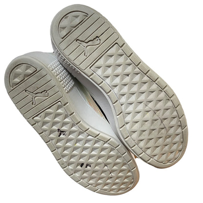 Close-up of beige sneaker soles with a textured pattern on a white background