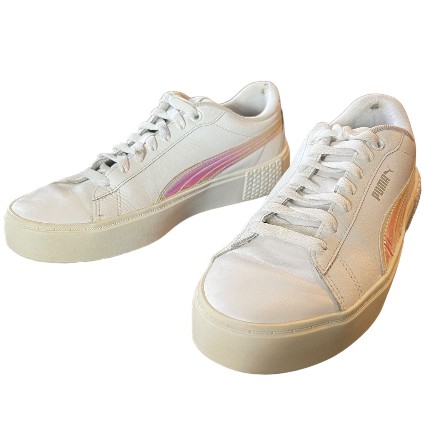 Pair of white sneakers with pink accents on a white background