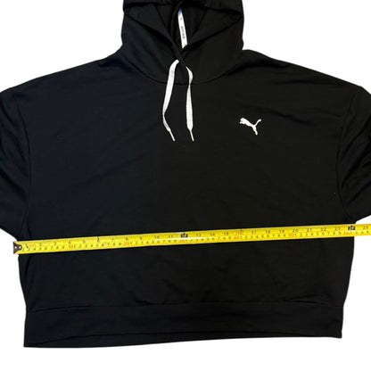 Black hoodie with a measuring tape around it on a white background