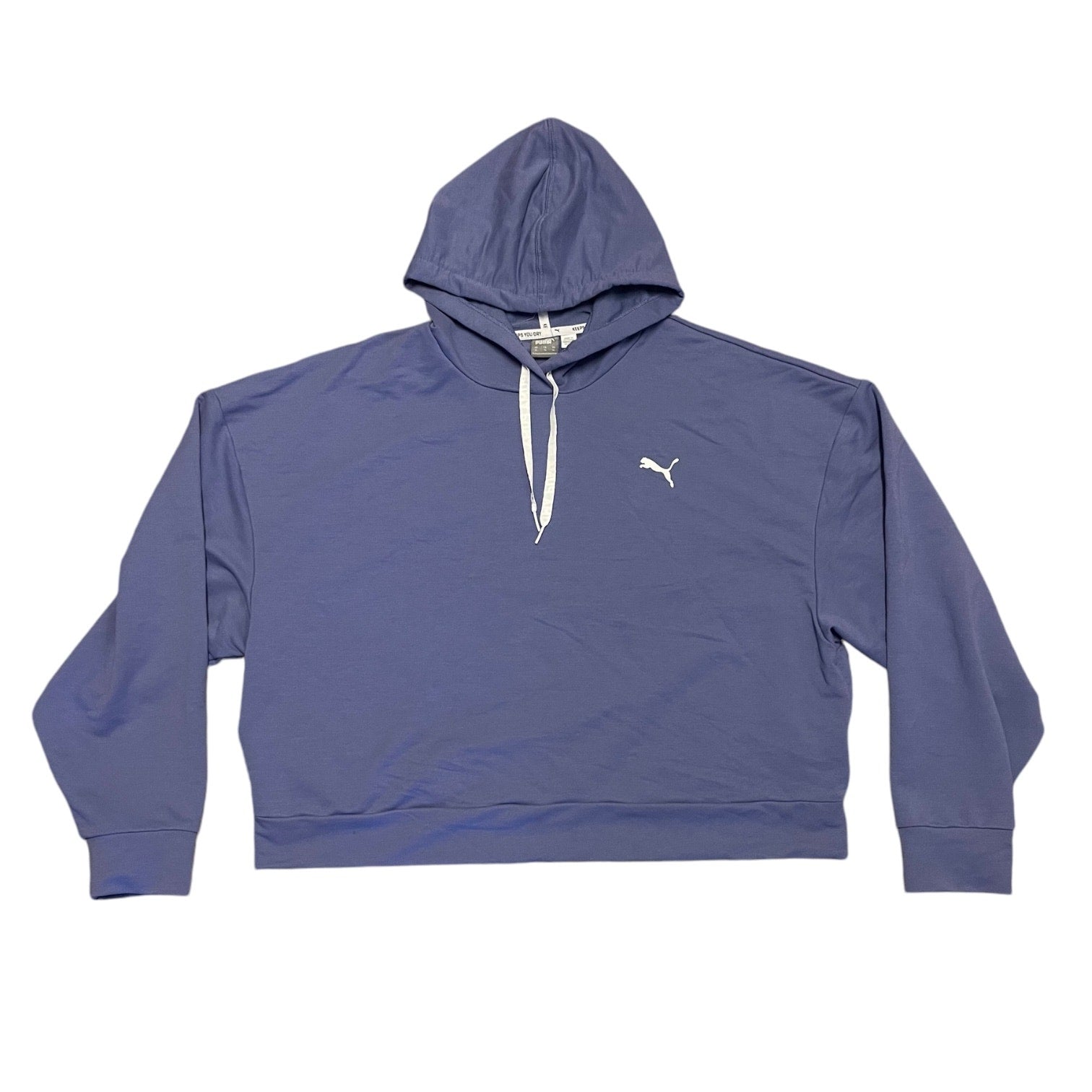 A Puma cropped pullover hoodie in a purple color, featuring white drawstrings and a white embroidered Puma logo on the left chest, laid flat against a white background.