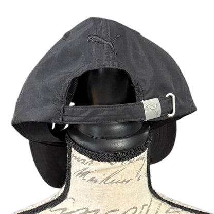 Black cap with a brand logo on a mannequin head against a white background