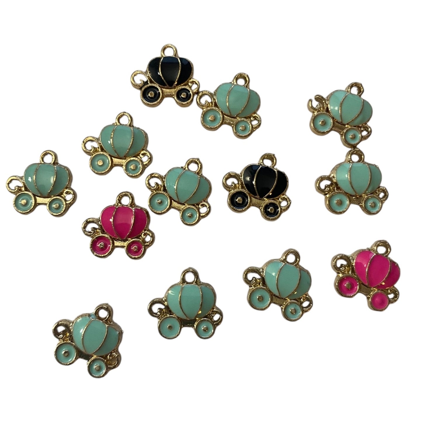 Collection of colorful pumpkin carriage charms on a white background