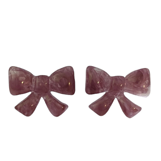 Pair of purple bow-shaped earrings on a white background