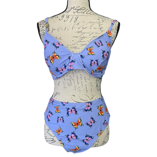 purple butterfly-patterned swimsuit on a mannequin with a white background