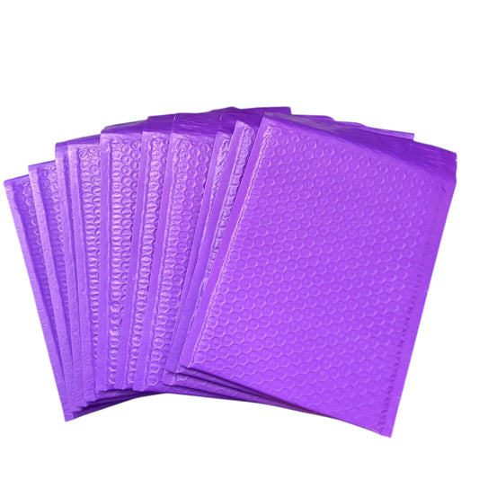 Purple bubble mailers stacked on a white background