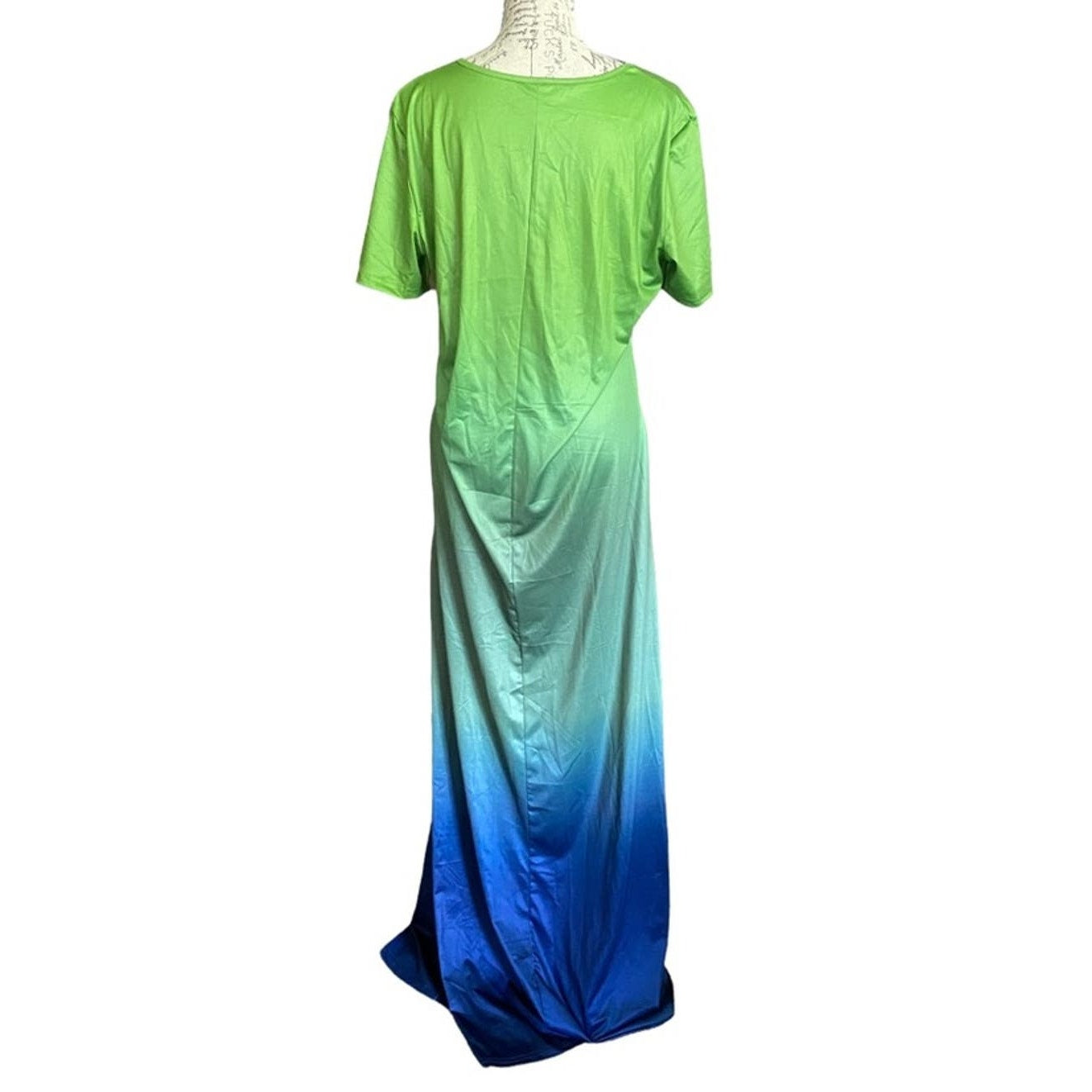 Back of Green to blue gradient dress on a mannequin against a white background