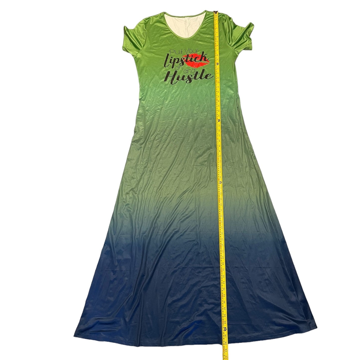 Green to blue gradient dress with 'Lipstick Hustle' text, displayed with a measuring tape.