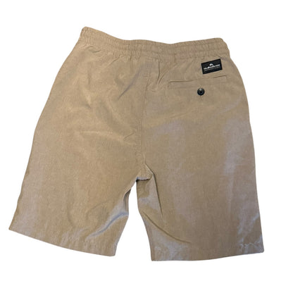 A pair of beige shorts with an elastic waistband, a back pocket with a button closure, and a small black brand label on the upper right side, shown against a plain white background.