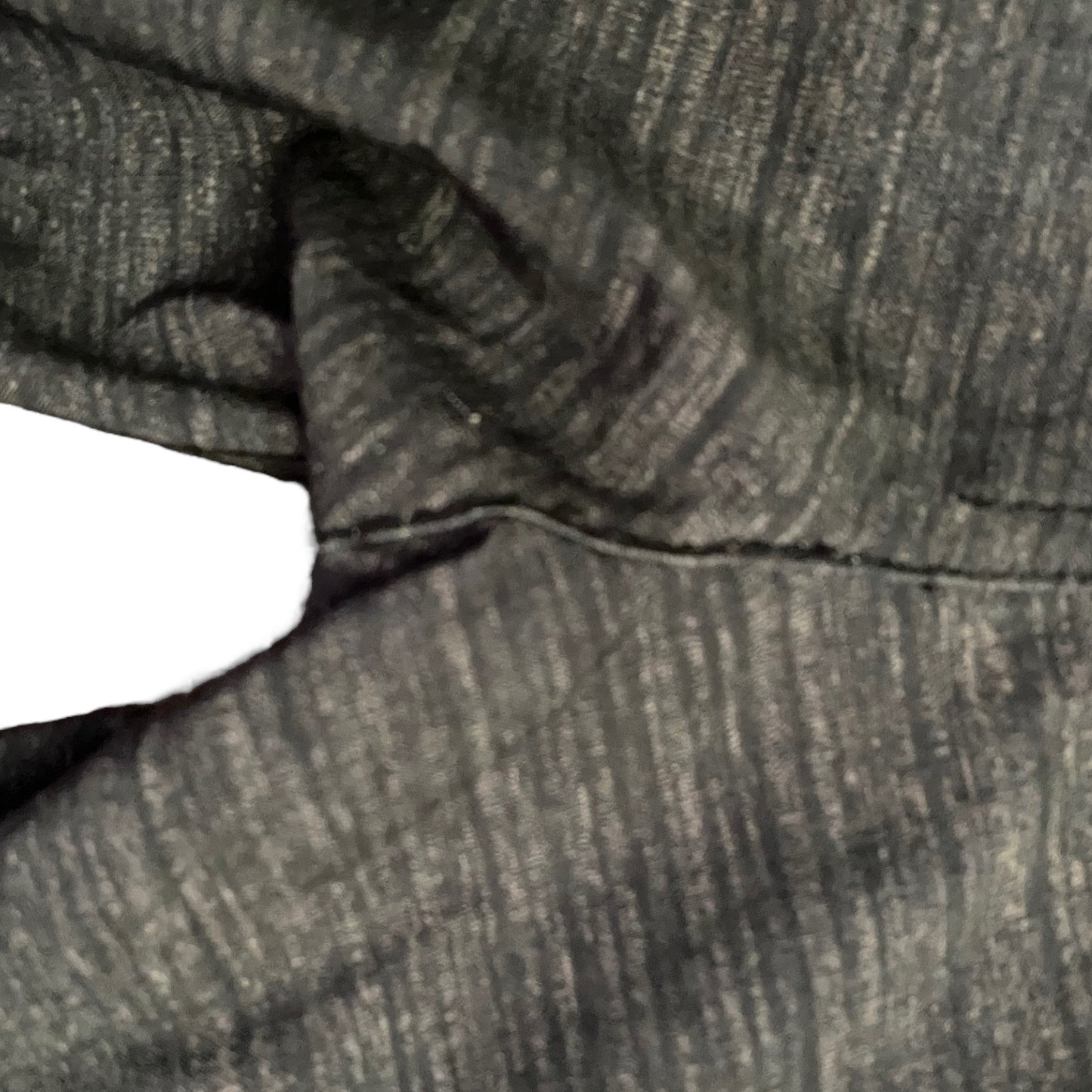 Close-up of repair on fabric with a white background