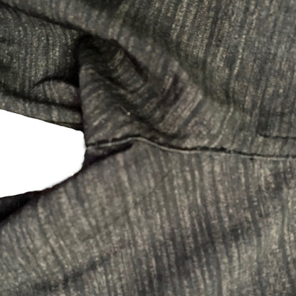 Close-up of repair on fabric with a white background