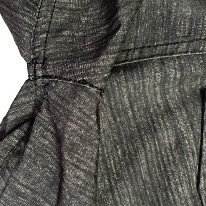 Close-up of repairs on gray fabric on a white background
