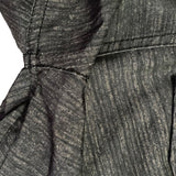 Close-up of repairs on gray fabric on a white background