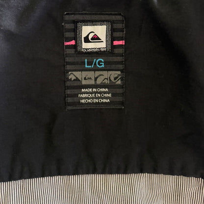 Clothing label on a black jacket with text and branding.