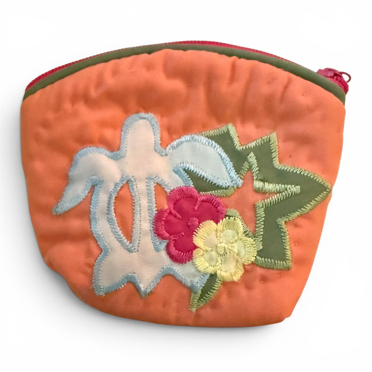 Orange pouch with floral and bird embroidery on a white background