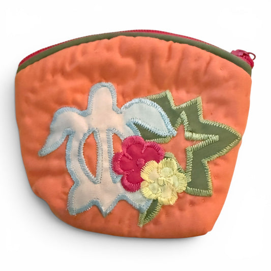 Orange pouch with floral and bird embroidery on a white background