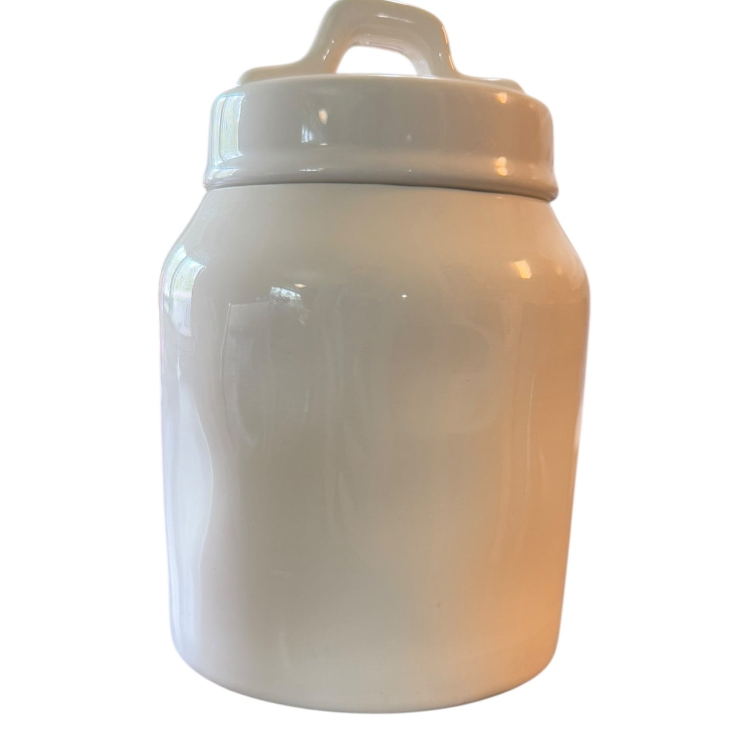 Back of White ceramic jar with a lid on a white background