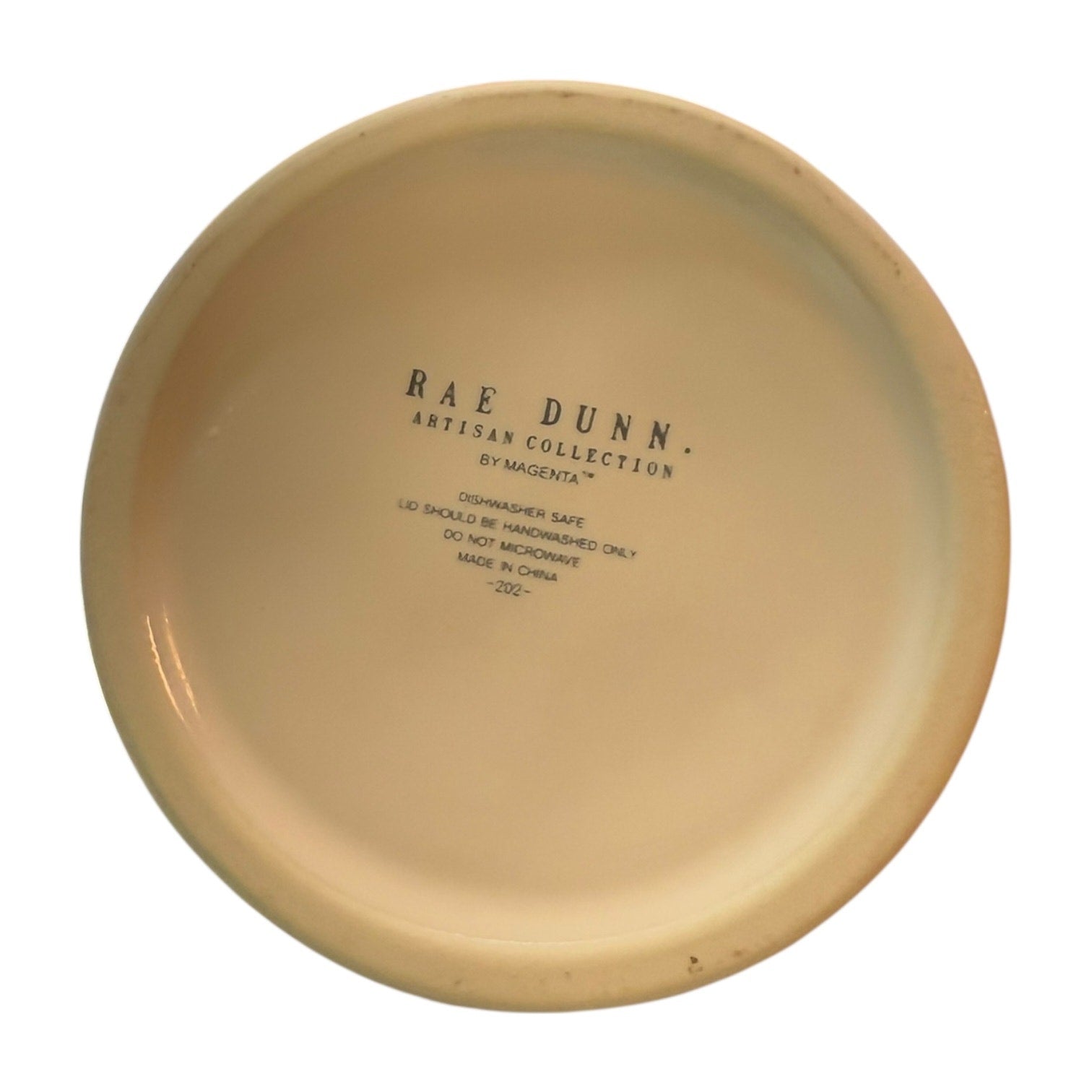 Bottom of ceramic jar with 'Rae Dunn Artisan Collection' text on a white background