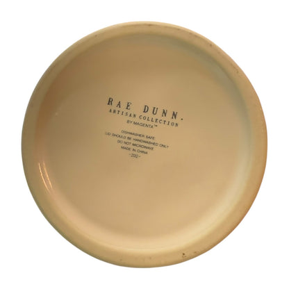 Bottom of ceramic jar with 'Rae Dunn Artisan Collection' text on a white background