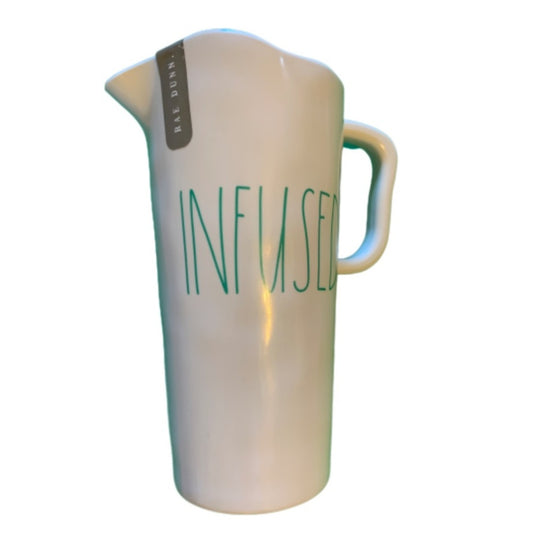 A white pitcher with green text reading 'INFUSED' on the front and a small gray tag near the spout, shown on a plain white background.