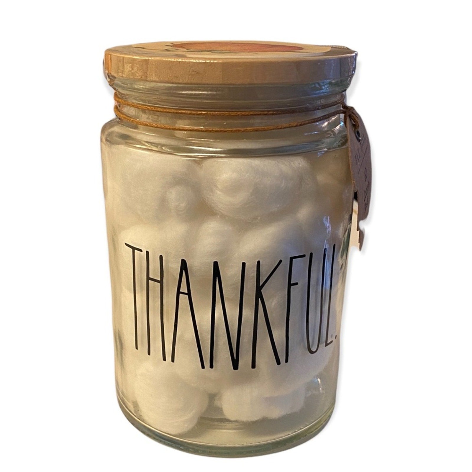 Glass jar with wooden lid and 'THANKFUL' text on a white background