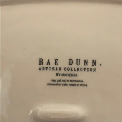 Back of Rae Dunn plate with writing
