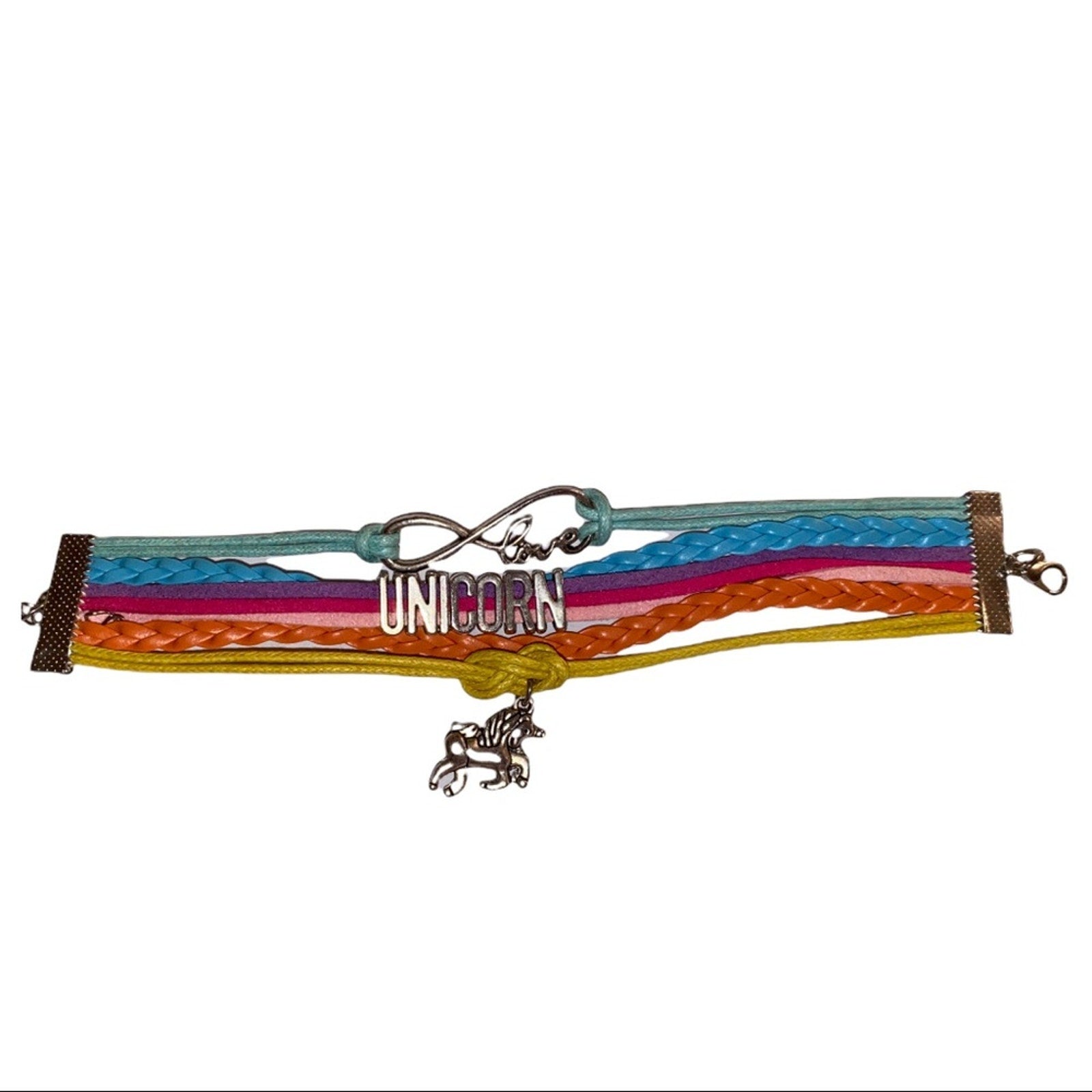A multicolor braided leather bracelet featuring a silver infinity knot, a silver 'UNICORN' charm, and a silver unicorn pendant, displayed on a plain white background.