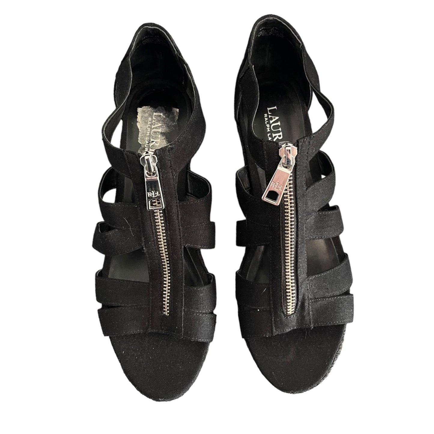 Top of Black strappy sandals with zippers on a white background