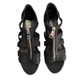 Top of Black strappy sandals with zippers on a white background