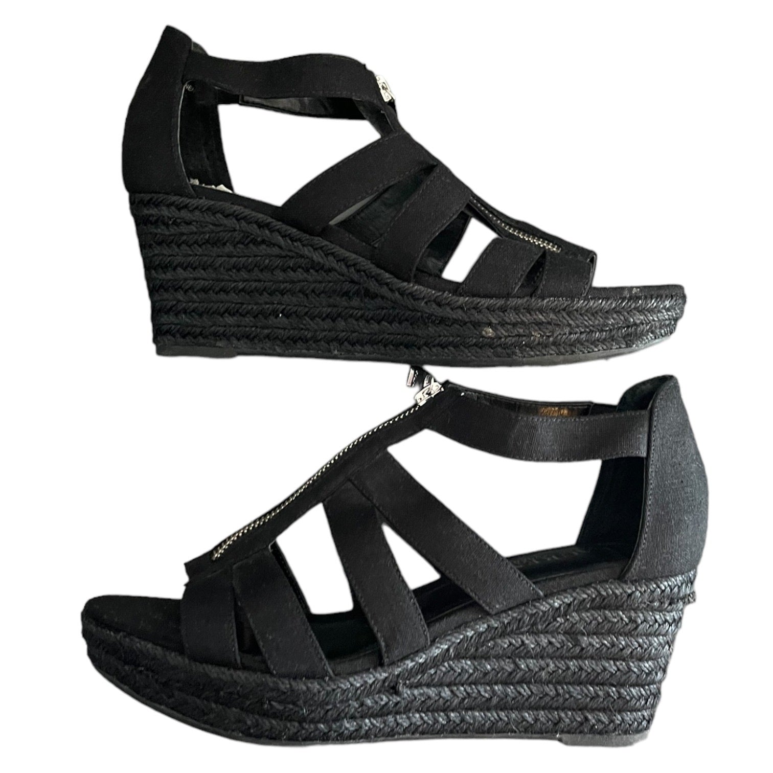 Black wedge sandals with espadrille sole on a white background