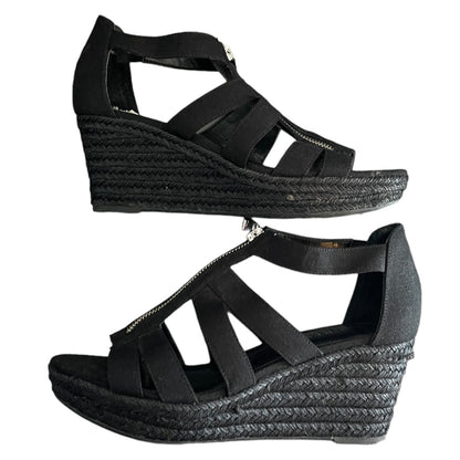 Black wedge sandals with espadrille sole on a white background